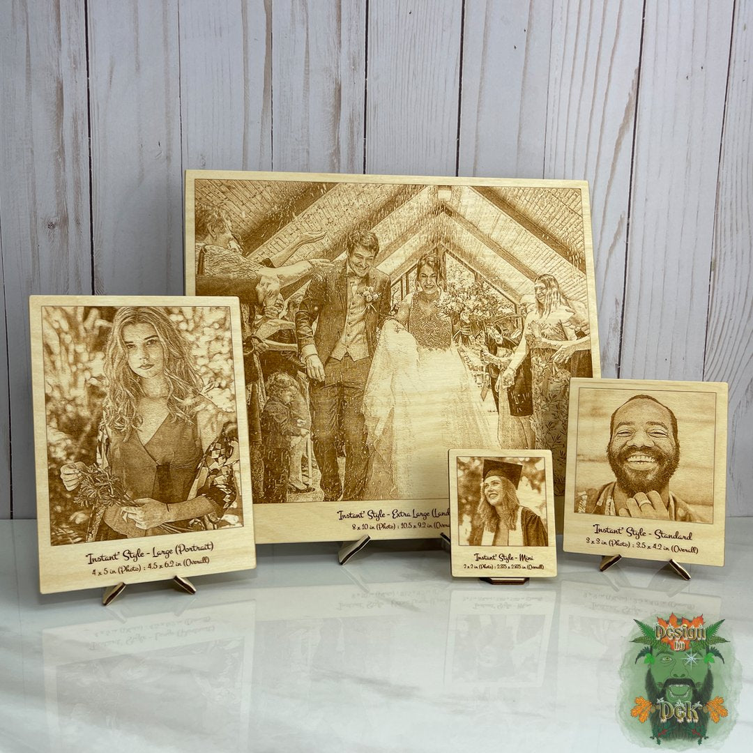 Set of wooden photo frames with engraved images on a wooden surface
