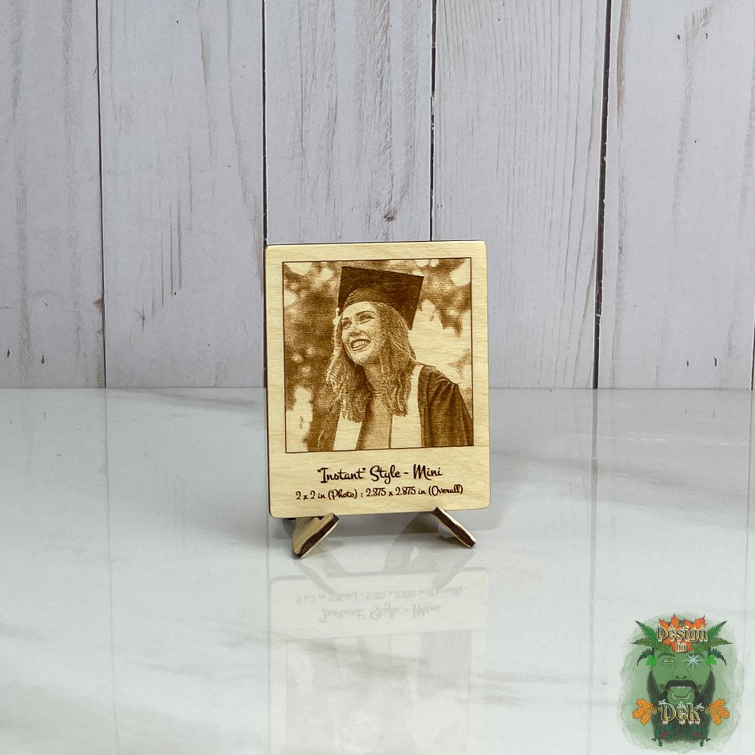 Wooden photo frame with a laser-cut portrait of a person in a graduation cap on a white surface.