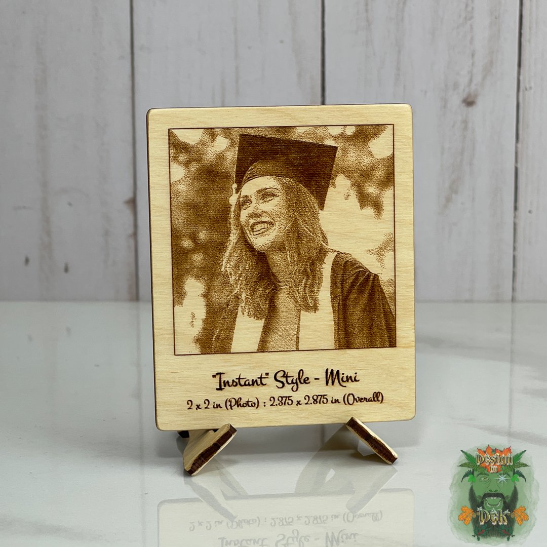 Wooden photo frame with a laser-cut portrait of a person in graduation attire on a wooden stand.
